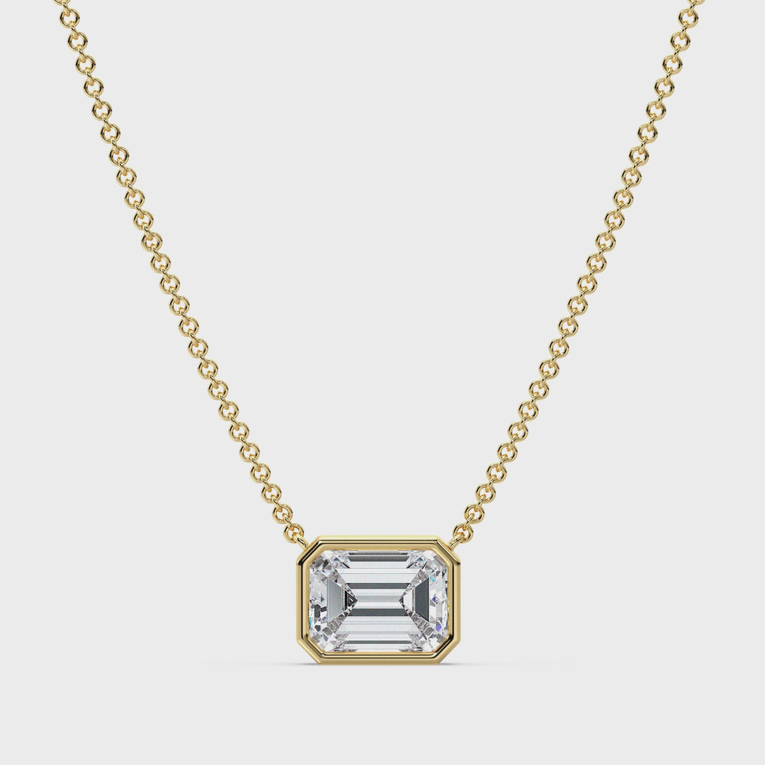 Video showcasing a stunning 2.00ct Emerald-Cut Lab-Grown Diamond Solitaire Pendant Necklace in Yellow Gold. The diamond, securely set in a sleek bezel setting, sparkles brilliantly as the pendant gently rotates to reveal its dazzling facets. The 18K Yellow Gold adds a warm, classic touch to the design, complemented by a delicately crafted chain for a seamless, elegant look